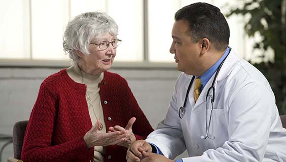 Older woman communicating with her doctor