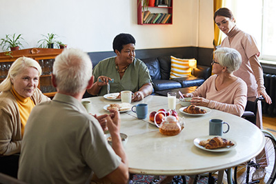 Older adults enjoy breakfast together at a facility