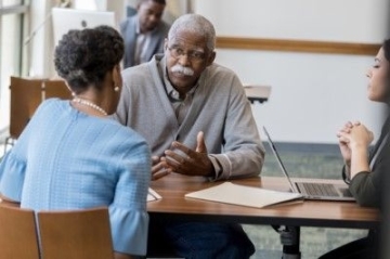 Older adult and his daughter discuss advance care planning.