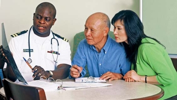 Doctor reviewing records and medical information with patient and family.