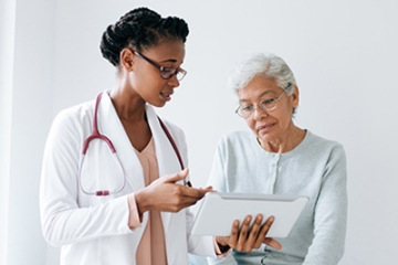 young black female doctor with older adult
