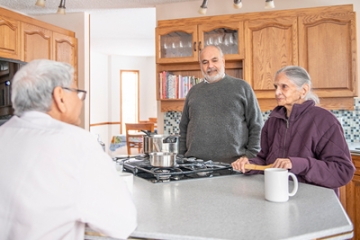 Older adult woman with early dementia talking with family and friends.