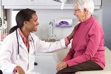 health care professional smiling with older patient