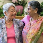 Asian Indian and East Asian women laughing