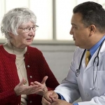 Older woman communicating with her doctor