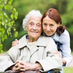 Older woman in a wheelchair and her daughter