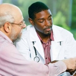 older man discussing sensitive subjects with his doctor