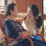 Older asian woman visits with granddaughter