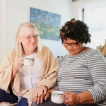 Shot of two elderly female friends hanging out drinking some tea